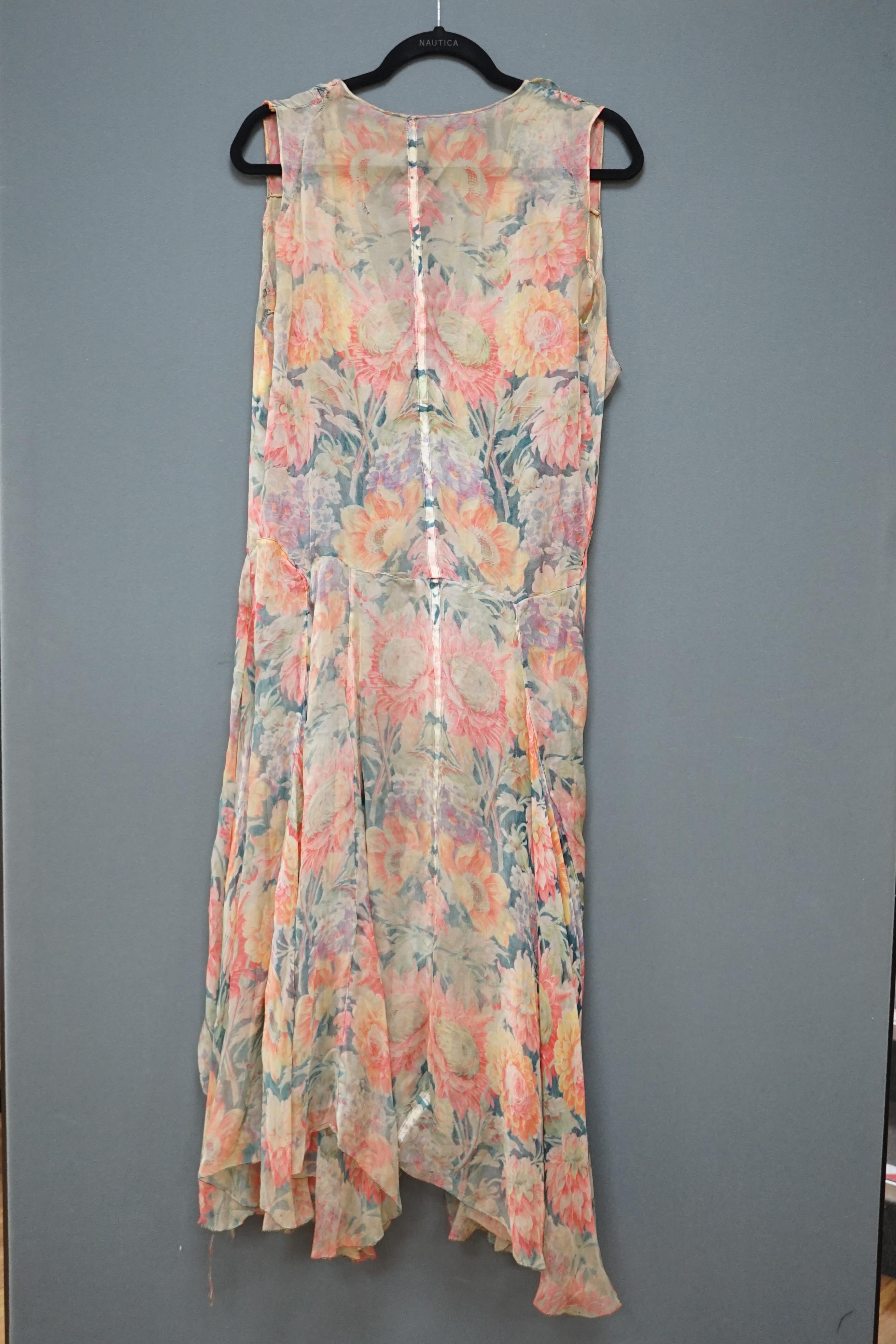 A 1930s printed sheer bias cut summer dress, hand made in a bright floral pattern silk organza style fabric, designed with a large collar and bias cut side panels. 42cm long from centre top back to hem. Condition - needs